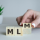 A picture of wooden blocks with the letters MLM, like Darren and Mike’s MLM.