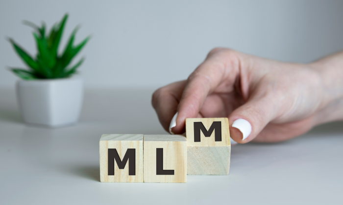 A picture of wooden blocks with the letters MLM, like Darren and Mike’s MLM.